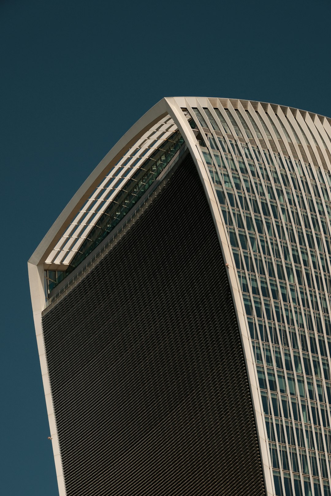 A very tall building with a clock on it's side