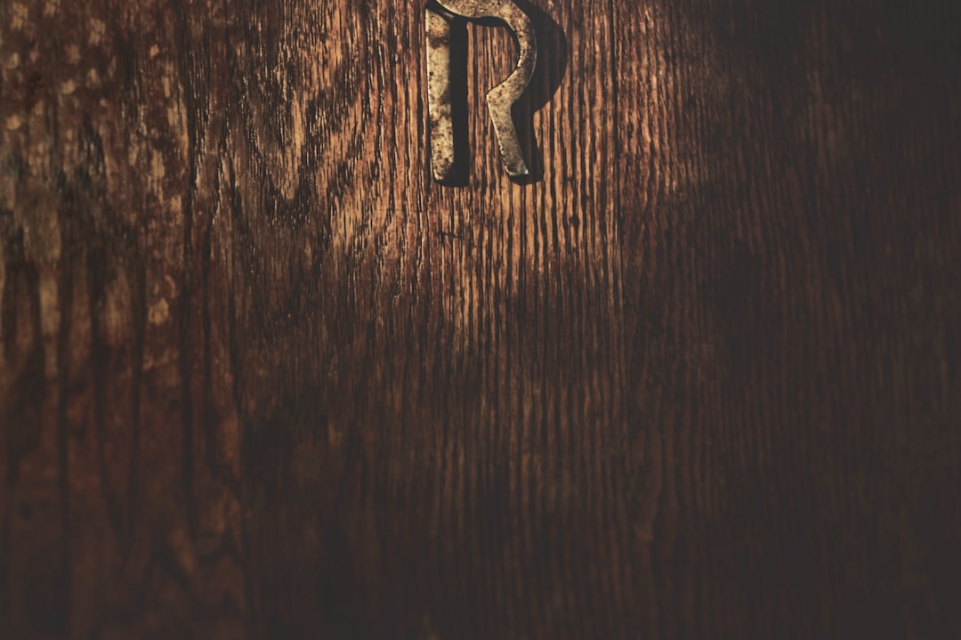 silver letter b on brown wooden table